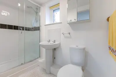 a bathroom with a toilet and a sink and a shower at 2 Bed in Redruth oc-gbells in Porkellis