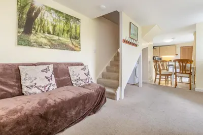 a living room with a couch and a staircase at 2 Bed in Redruth oc-gbells in Porkellis