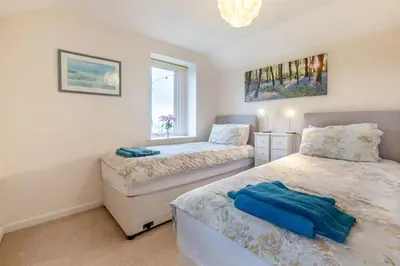 a bedroom with two beds and a window at 2 Bed in Redruth oc-gbells in Porkellis