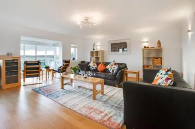 a living room with two couches and a table at 4 Bed in Marazion oc-gwynsa in Marazion