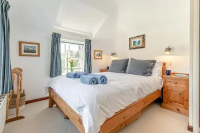 a bedroom with a bed with blue towels on it at 3 Bed in Helford oc-hccott in Helford