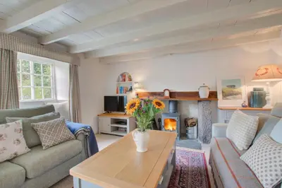 a living room with a couch and a fireplace at 3 Bed in Helford oc-hcmimo in Helford