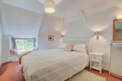a white bedroom with a bed and a window at 3 Bed in Helford oc-hcmimo in Helford