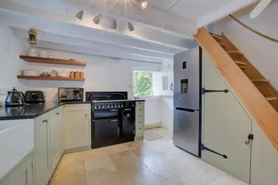 a kitchen with a black refrigerator and a stove at 3 Bed in Helford oc-hcmimo in Helford