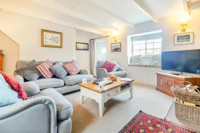 a living room with two couches and a tv at 2 Bed in Helford oc-hcpopi in Helford