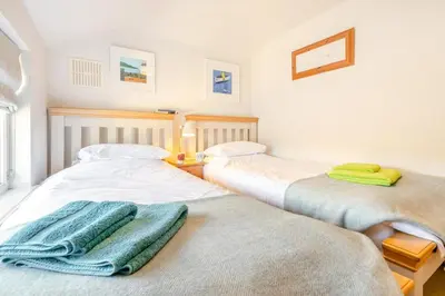 a room with two beds with towels on them at 2 Bed in Helford oc-hcpopi in Helford