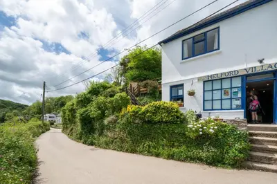 a building on a dirt road in front of a building at 2 Bed in Helford oc-hcview in Helford