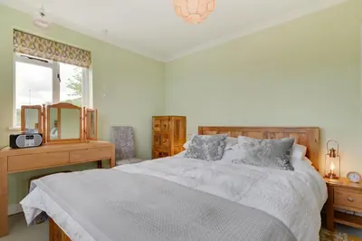 a bedroom with a bed and a desk and a window at 2 Bed in Helford oc-hcview in Helford