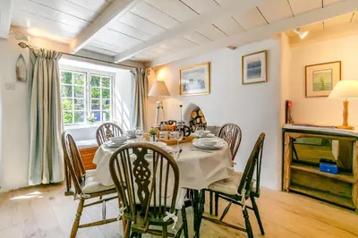 a dining room with a table and chairs at 3 Bed in Helford oc-hcwedn in Helford