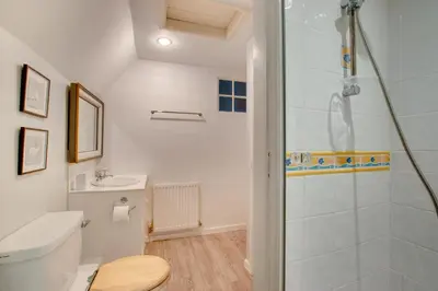 a bathroom with a shower and a toilet and a sink at 3 Bed in Helford oc-hcwell in Helford