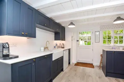 a kitchen with blue cabinets and white counter tops at 3 Bed in Helford oc-hcwell in Helford