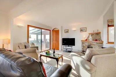 a living room with couches and a tv and a fireplace at 3 Bed in Porthleven oc-ingnoo in Porthleven