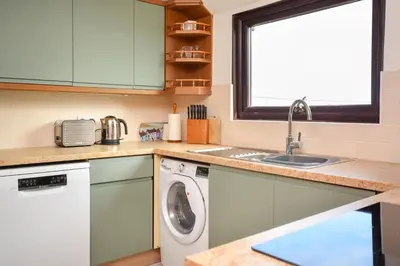 a kitchen with a washing machine and a sink at 3 Bed in Porthleven oc-ingnoo in Porthleven