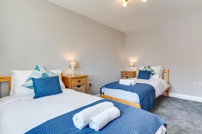 two beds in a room with blue and white at 2 Bed in Fowey oc-jackda in Fowey