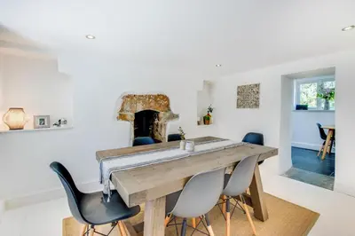 a dining room with a wooden table and chairs at 2 Bed in Breage oc-jobcot in Breage