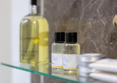 two bottles of liquids sitting on a glass shelf at 2 Bed in Breage oc-jobcot in Breage