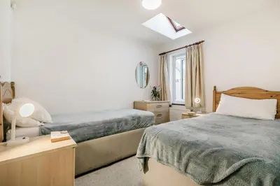 a hotel room with two beds and a window at 2 Bed in Looe oc-l00055 in Trelaske
