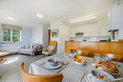 a kitchen and living room with a table with food on it at 2 Bed in Looe oc-l00055 in Trelaske