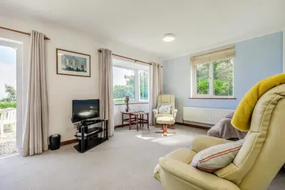 a living room with a couch and a television at 2 Bed in Looe oc-l00055 in Trelaske