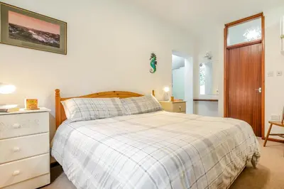 a bedroom with a bed and a dresser and a window at 1 Bed in Looe oc-l00063 in Trelaske