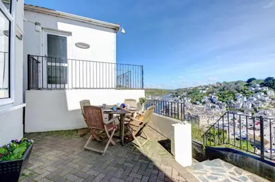 a patio with a table and chairs on a balcony at 2 Bed in Looe oc-l10082 in Looe