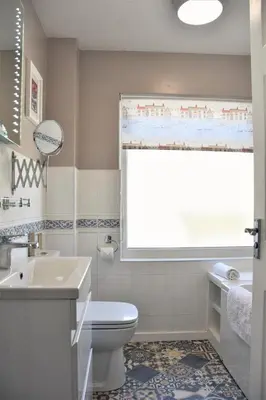 a bathroom with a toilet and a sink and a window at 2 Bed in Looe oc-l10082 in Looe