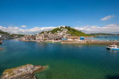 a river with a town and a boat in the water at 3 Bed in Looe oc-l10098 in Looe