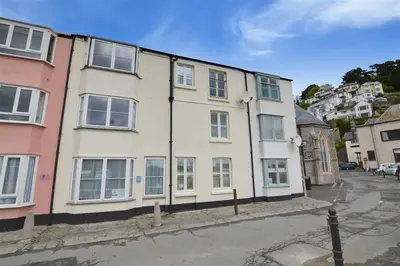 a white building with windows on a street at 3 Bed in Looe oc-l10098 in Looe