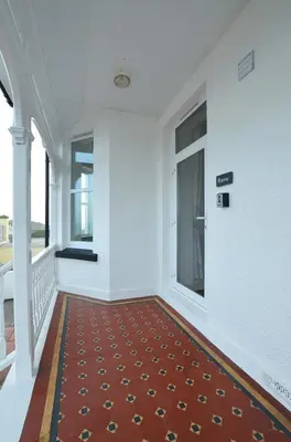 an empty room with a red carpet and windows at 1 Bed in Looe oc-l30006 in Looe