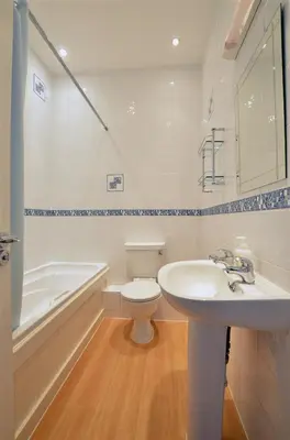 a bathroom with a sink and a toilet and a tub at 1 Bed in Looe oc-l30006 in Looe