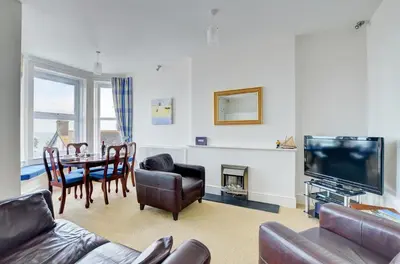 a living room with a television and a table and chairs at 1 Bed in Looe oc-l30006 in Looe