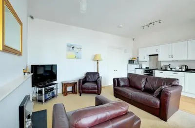 a living room with a couch and a tv and a kitchen at 1 Bed in Looe oc-l30006 in Looe