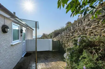 a room with a view of a stone wall at 1 Bed in Looe oc-l30008 in Looe