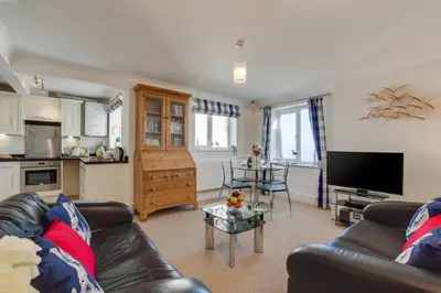 a living room with a couch and a table at 1 Bed in Looe oc-l30008 in Looe