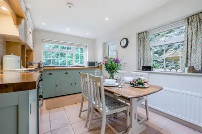 a kitchen with a table with flowers on it at 2 Bed in Looe oc-l30015 in Lansallos
