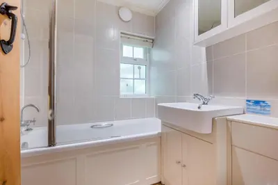 a white bathroom with a sink and a shower at 2 Bed in Looe oc-l30015 in Lansallos