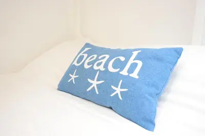 a blue pillow with the word beach written on it at 2 Bed in Looe oc-l30020 in Looe