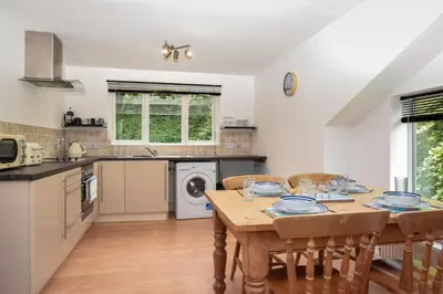 a kitchen with a table and chairs in a kitchen at 2 Bed in Looe oc-l30020 in Looe