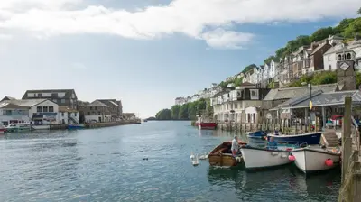 a river with boats docked in a town with houses at 2 Bed in Looe oc-l30020 in Looe