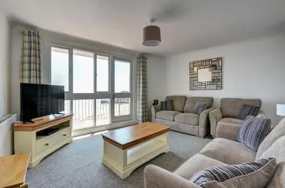 a living room with a couch and a tv at 2 Bed in Looe oc-l30035 in Looe