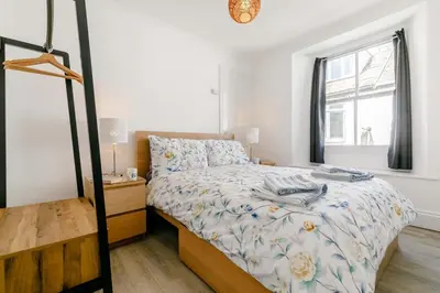 a small bedroom with a bed and a window at 1 Bed in Looe oc-l30038 in Looe