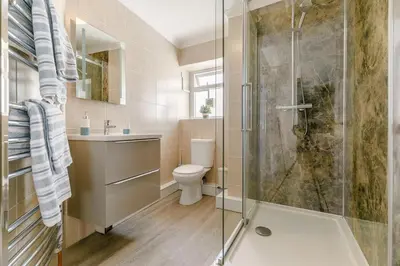 a bathroom with a shower and a toilet and a sink at 1 Bed in Looe oc-l30038 in Looe