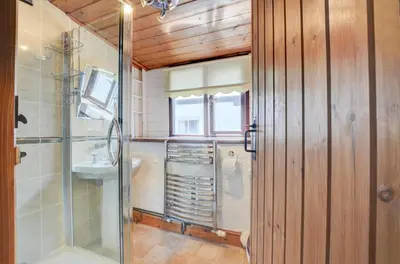 a bathroom with a glass shower and a sink at 4 Bed in Looe oc-l30047 in Looe