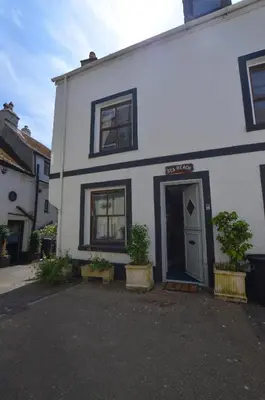 a white house with two potted plants in front of it at 4 Bed in Looe oc-l30047 in Looe