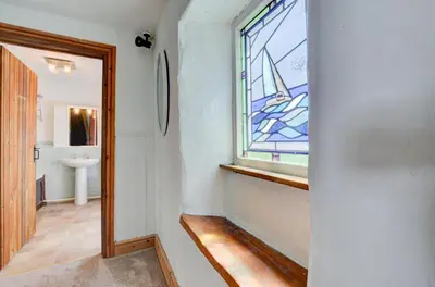 a bathroom with a stained glass window and a sink at 4 Bed in Looe oc-l30047 in Looe
