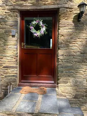 a wooden door with a wreath on it at The parlour in Bodmin