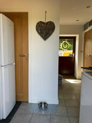 a kitchen with a heart hanging on the wall at The parlour in Bodmin