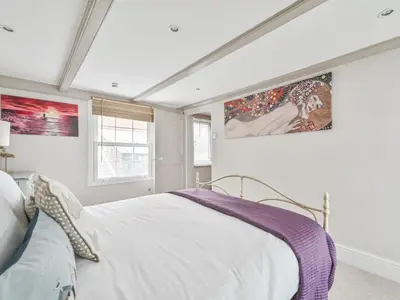 a bedroom with a white bed in a room at Holiday Home Mariners Rest by Interhome in Mevagissey