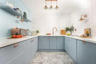 a kitchen with blue cabinets and white walls at Azenor House - Central Location - Hot Tub - Free Parking & WiFi - 3 Pets Accepted in St Ives