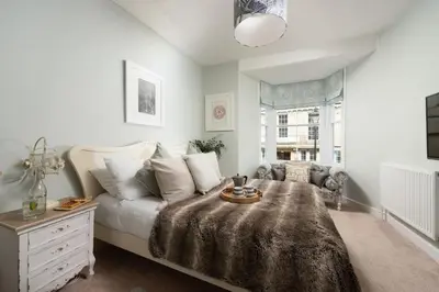 a living room with a bed and a couch at Azenor House - Central Location - Hot Tub - Free Parking & WiFi - 3 Pets Accepted in St Ives
